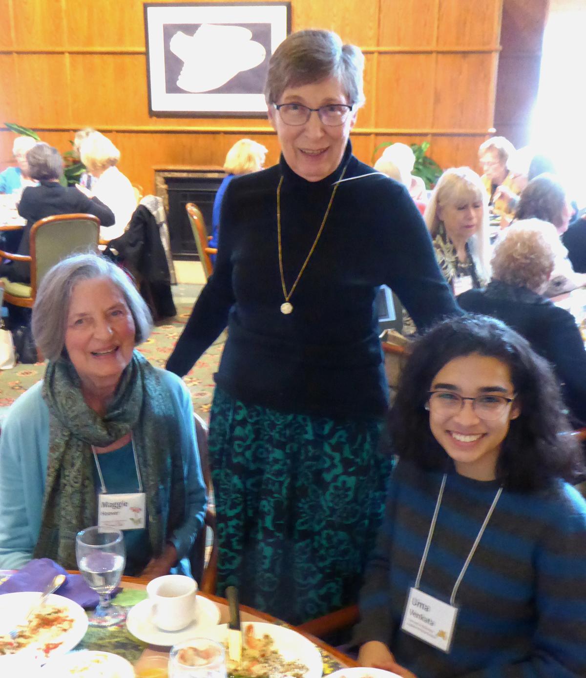 Women's club members at a luncheon program pose for a photo